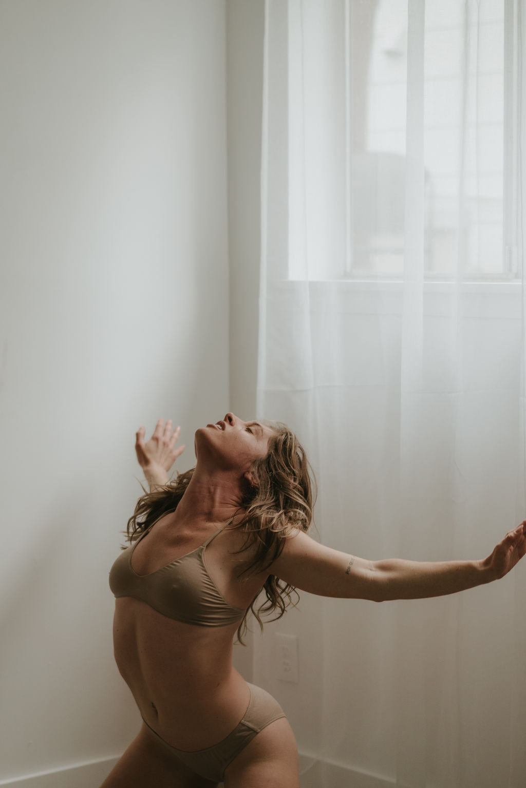 Brittini Burton moving freely in a sunlit studio