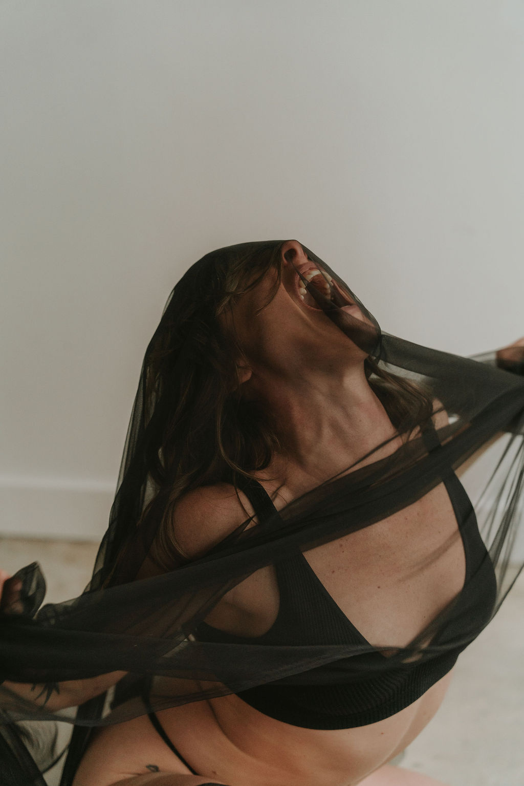 A woman with eyes closed, turned toward the light