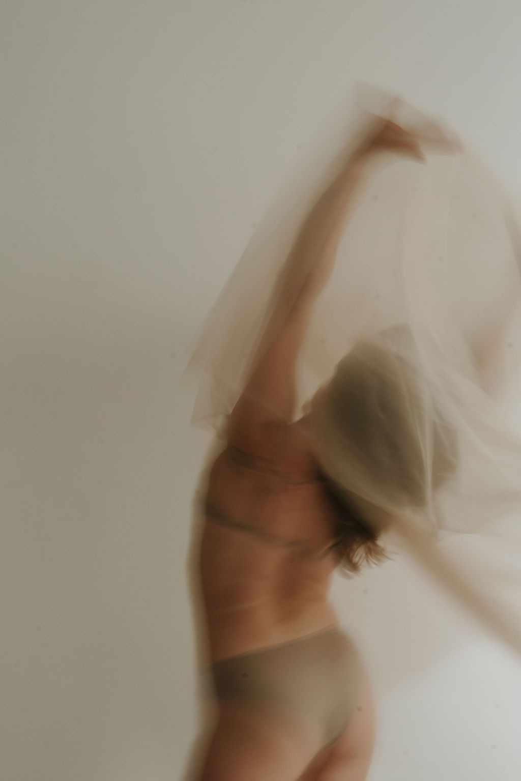 A woman bathed in soft light, fully at ease